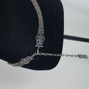 Silver tone metal belt with black gemstones